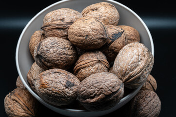 A composition of typically autumnal fruits such as walnuts, enhancing their beauty and detail.