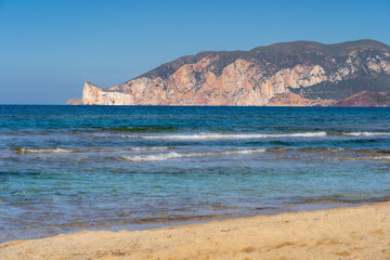 the beautiful beach of Spiaggia di Plagemesu on the island of Sardinia (Italy) during the day with a view of Sugar Loaf (Scoglio Pan di Zucchero)