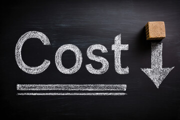 Word cost written in chalk on blackboard with stacked coins, small money bag, and calculator, symbolizing finance, expense, and budgeting concepts.