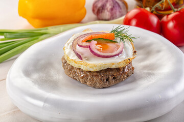 Beefsteak chop with roasted egg