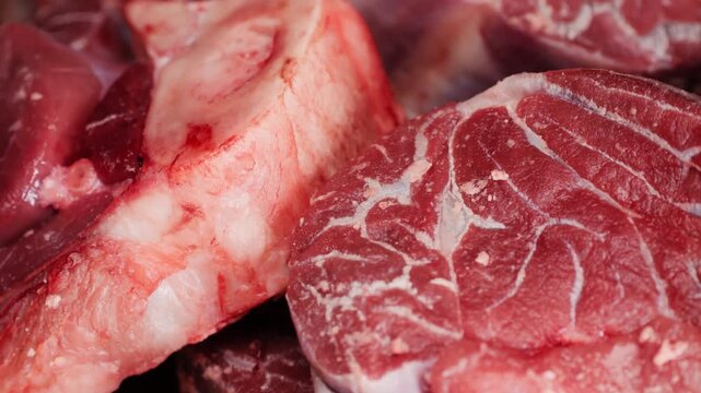 Fresh beef ossobuco steak with salt, spices and herbs on textured background, bones. 