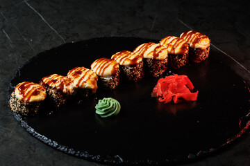 Assorted sushi rolls with fresh ingredients on a dark background. Ideal for restaurant, menu or Japanese food design.
