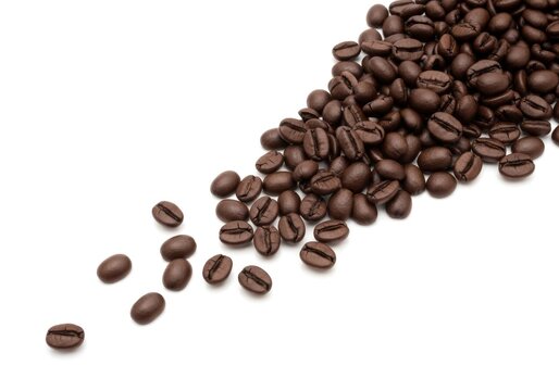 Aromatic roasted coffee beans spilling across a pristine white isolated background with copy space