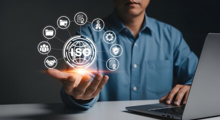 Businessman holding a glowing iso certification symbol with surrounding icons representing quality management, standards, and business processes, symbolizing international standards and compliance