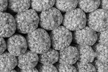 Kettle corn (popcorn) plastic package stack pile for sale at festival fair in black and white