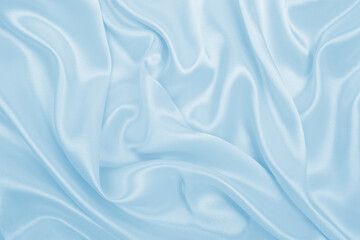 Smooth elegant blue silk or satin luxury cloth texture as abstract background. Luxurious background design