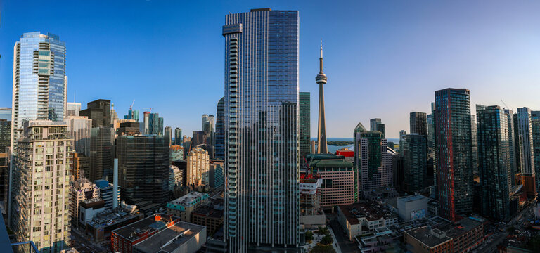 Panoramic view of downtown Toronto, Ontario Canada cityscape. Bustling city life with modern skyscrapers and water in the background. 