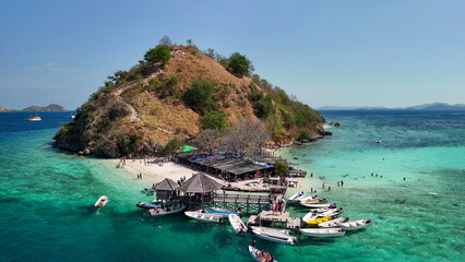 Drone view of Pulau Kelor surrounded by crystal clear waters in Komodo archipelago, Indonesia