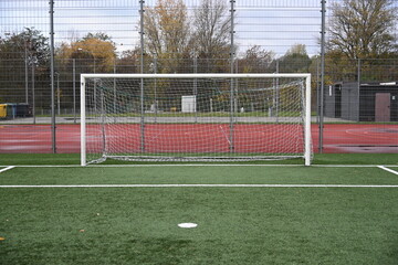 empty football field with goal and lines
