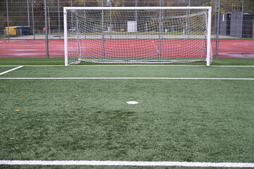 empty football field with goal and lines
