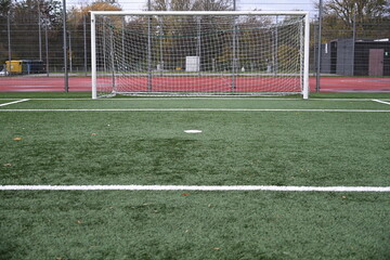 empty football field with goal and lines
