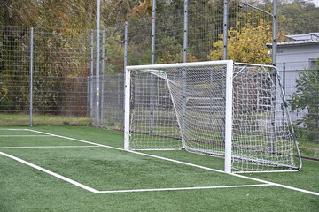 empty football field with goal and lines
