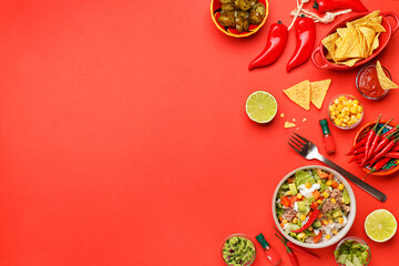 Set of traditional mexican dishes - burrito bowl, nachos, guacamole and salsa dressing, chili peppers, chopped jalapeno and lime on red background. Overhead view, flat lay, copy space