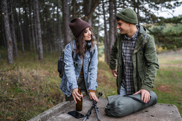 Young couple preparing for camping trip in forest