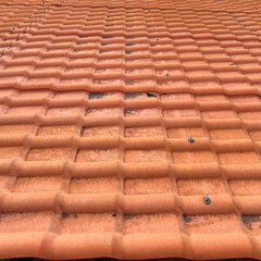 Perspective view of a background of traditional orange tiles - architectural detail.