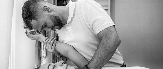 Physiotherapy treatment on a young woman’s shoulder in a professional clinic