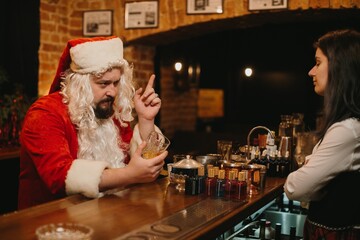 Santa claus ordering drinks at bar after christmas