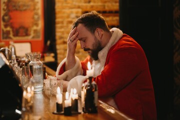 Santa claus taking a stressful break at bar