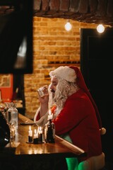 Santa claus unwinding at rustic bar counter