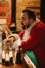 Santa claus taking a relaxing drink at bar