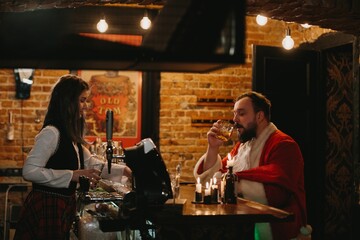 Tired santa having a drink at a cozy bar