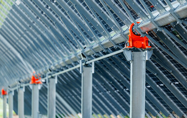 Naklejka premium Solar panel installation Automatic sun tracking system, orange connectors for sustainable energy solutions
