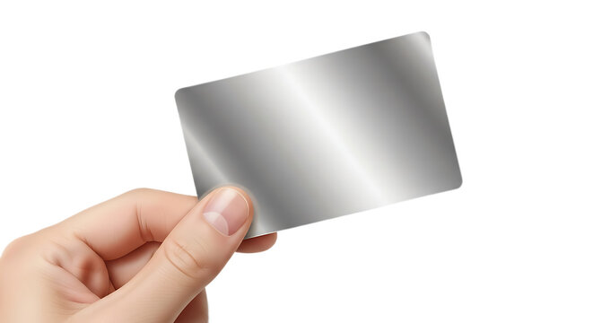 A hand holding a shiny metallic card against a black background in a studio setting close up view