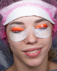 Caucasian woman undergoing eyelash lamination procedure. top view. 