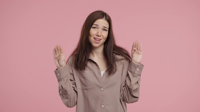 Young charming woman mimics talking with hand while rolling her eyes, expressing sarcasm or annoyance. Fits themes like boredom, irony, communication overload, emotional reactions