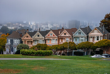 Colorful Painted Ladies line Alamo Square in San Francisco as downtown towers rise through coastal...
