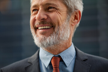 Mature man smiling in business attire