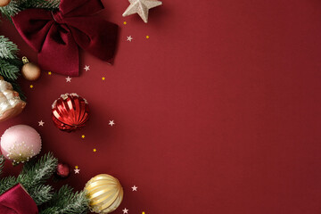 Top-left Christmas corner with velvet bow, gold star, and shiny baubles on red background. Ideal for holiday greetings, banners, and seasonal promotions.