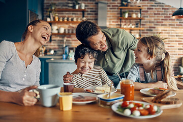 Happy family enjoying breakfast at home