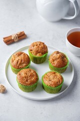 Cinnamon muffins with pear slices in a plate on a white background