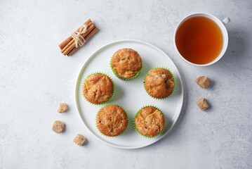 Cinnamon muffins with pear slices in a plate on a white background