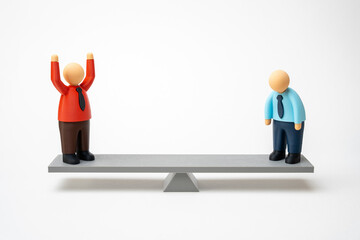 The red office worker in a standing ovation over the blue one on the scales. The boss puts pressure...