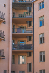 Residential apartment balconies with railings.