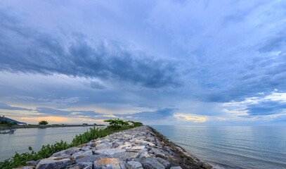 Rocky shoreline with a cloudy sky in the background