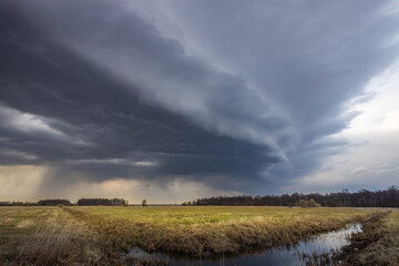 Stormy sky with dark clouds and a field of grass