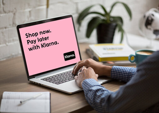 Person using laptop for klarna buy now pay later service