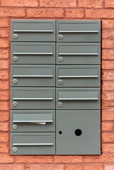 mailbox on the wall,Metal mailboxes, traditional wall-mounted mailboxes, Multiple metal gray postbox in a lobby of apartments.