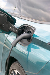 Electric car is charging in shopping mall parking lot,The electric machine stopped at the charging station to recharge.