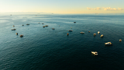 Fishing boats on the Bosphorus in Istanbul, Turkey on a bright day.