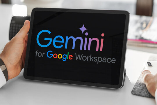 Hands holding tablet displaying gemini for google workspace logo