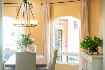 A beautifully arranged dining room with a table, chairs, and a chandelier