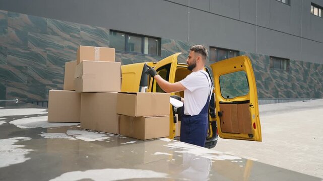 Delivery man unloading parcel from yellow van