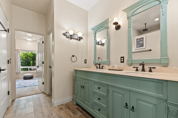 A spacious bathroom that features two sinks and also includes two mirrors