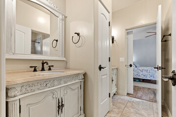 A welldesigned bathroom that features a sink, mirror, and cabinets