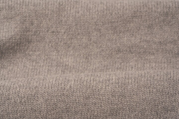 Soft grey merino wool sweater texture as a background.