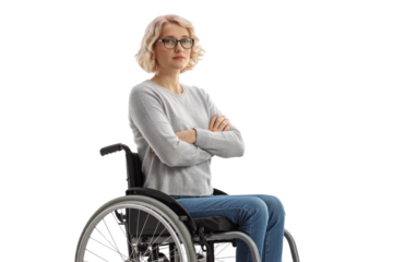 A serious blonde woman with glasses sits in a wheelchair, arms crossed, looking directly at the viewer with a neutral expression. background removed